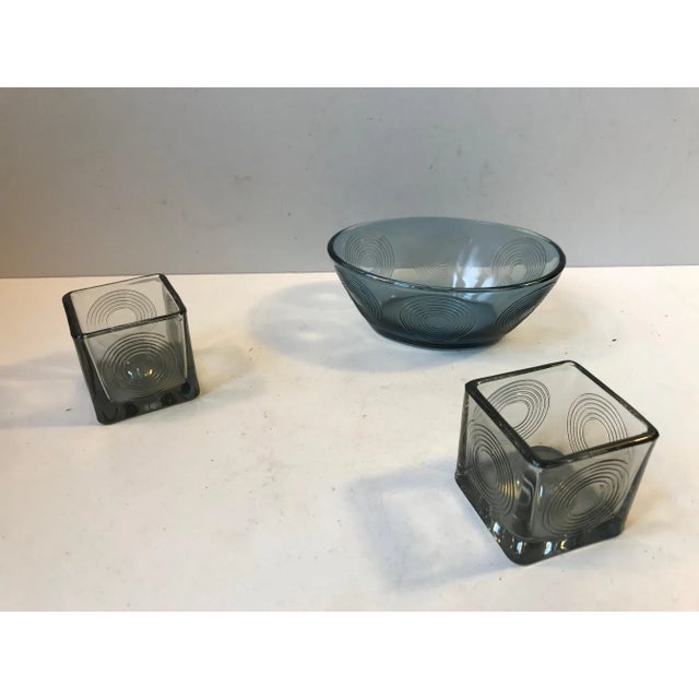 Matching pair of candlesticks or tea light holders and accompanying bowl. This cubist design from Per Lütken/Holmegaard is...