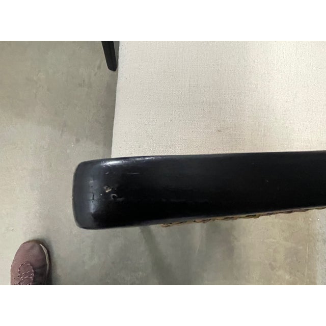 A pair of wood, linen, and natural cane armchairs