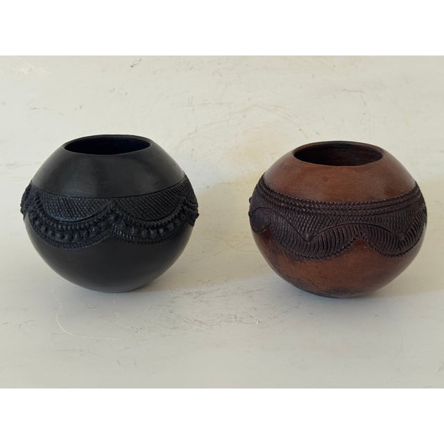 Beautiful hand built Zulu Beer Cup with redish/black burnished surface. Jabulile Nala Zulu ceramics play a central role in...
