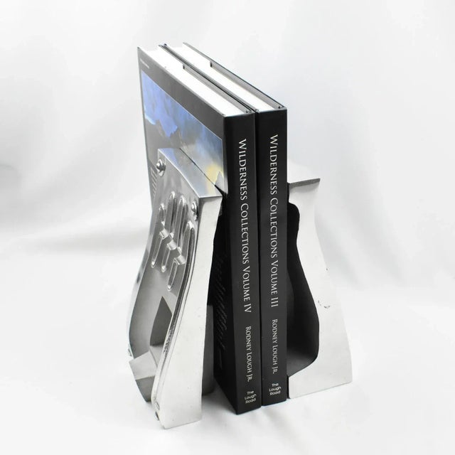 This stunning pair of industrial stainless steel hand or glove molds has their use turned into bookends. Those forms are...