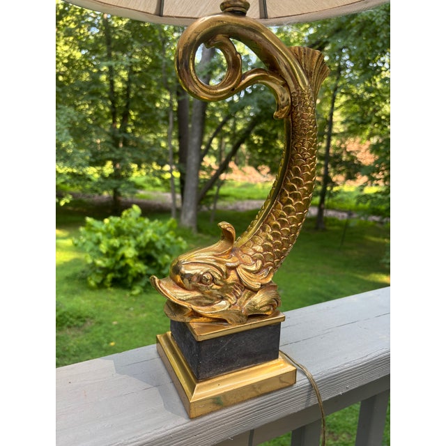 A large pair of solid brass dolphins with gold wash, mounted as lamps on black plinth bases. Incredible detail with fins...