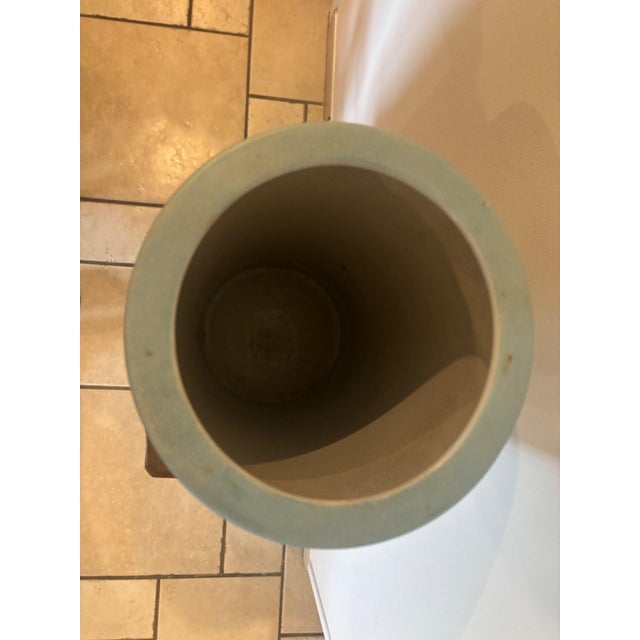 A cylindrical glazed porcelain umbrella stand, a distinctive piece from an identified late 19th-century manufacturer. Its...