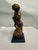 This vintage Borghese cherub statue features a detailed gold-tone finish and stands approximately 7 inches tall. It is...