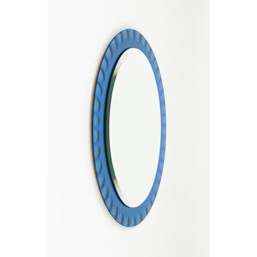 Midcentury amazing oval wall mirror with blue frame by Antonio Lupi for Cristal Luxor. Made in Italy in the 1960s. The...