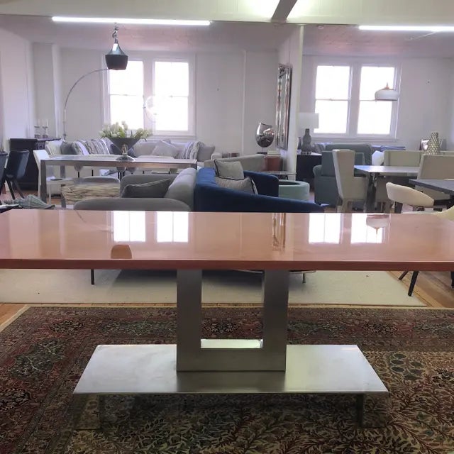 The Brueton Plattus dining table, designed by Stanley J. Friedman, showcases a refined modern aesthetic defined by its...