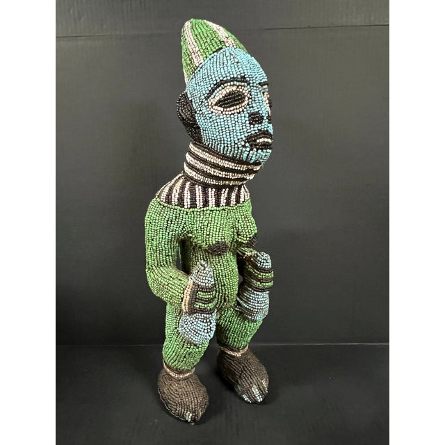 ITEM NAME: African Tribal Art Carved Wood and Beaded Bamileke Statue ORIGIN: Cameroon AGES: Late 20th Century MATERIALS:...