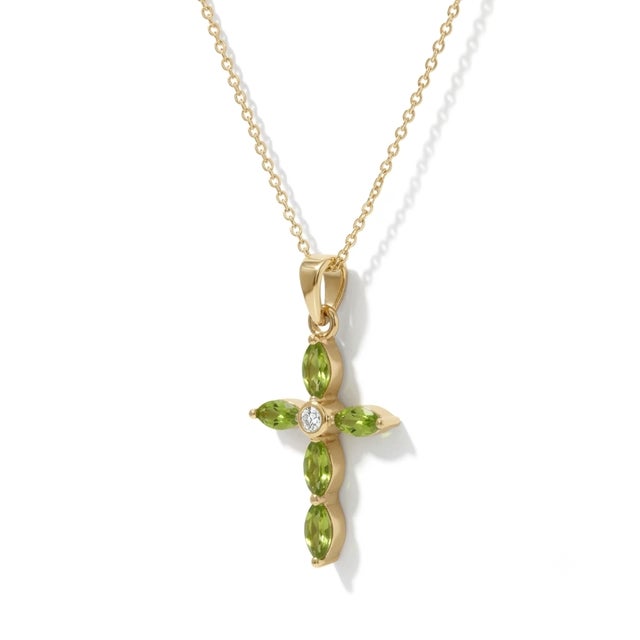 Celebrate fresh beginnings and refined grace with this stunning Marquise Peridot Cross Necklace. This delicate piece...