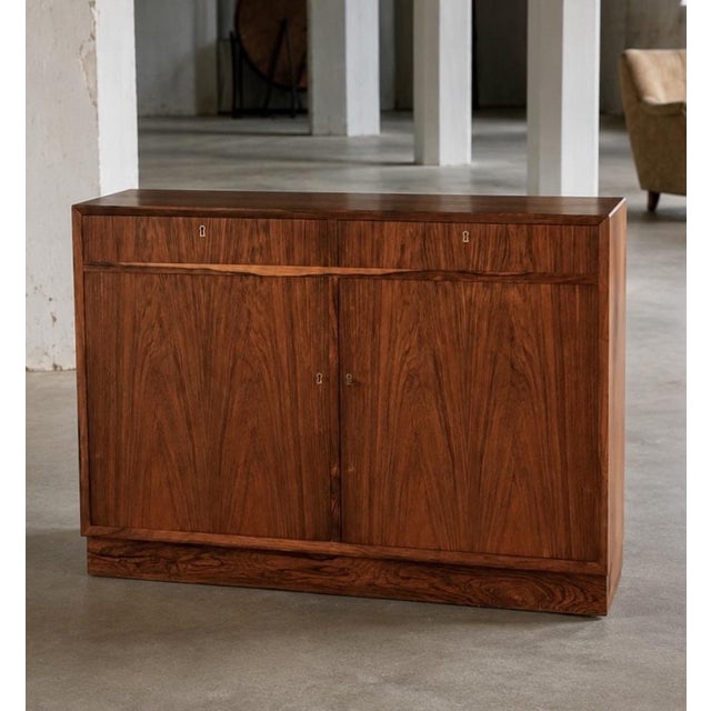 Sideboard attributed to o. Bank larsen for skjern møbelfabrik. denmark, 1970s. executed with two drawers and sliding...