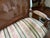 A vintage French Provincial Louis XVI style cane back settee circa mid-20th century, featuring cane, solid wood frame,...