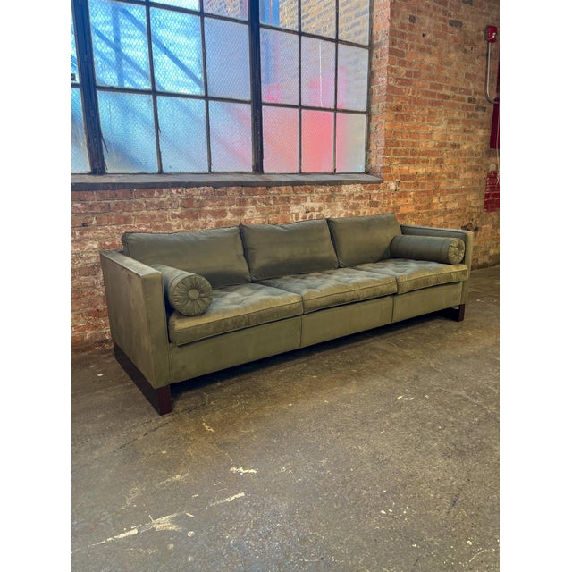 Three-seat sofa attributed to Mies van der Rohe, upholstered in soft green suede. Features a tufted seat, loose back...
