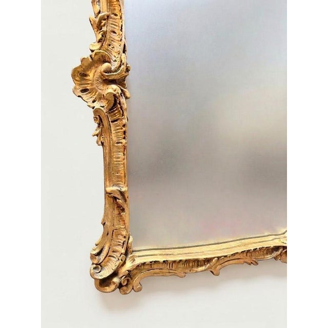 An exceptionally ornate and highly decorative French style panel mirror. Richly detailed throughout, the frame is adorned...