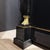 An Empire Inspired Four-Door Sideboard Designed by De Coene Frères. Black Lacquer with patinated Bronze details, a Central...