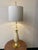 A rare pearlescent enamelled table lamp in carved wood and brass detailing depicting a pineapple att. to Silnovo. It has...