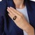 This striking vintage ring centers on a lustrous Tahitian pearl measuring approximately 9.69mm, displaying a rich, dark...