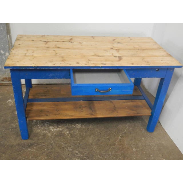 Made of blue-stained fir wood with a central drawer and fixed shelf. The lower space is 48 cm. The top has been replaced...