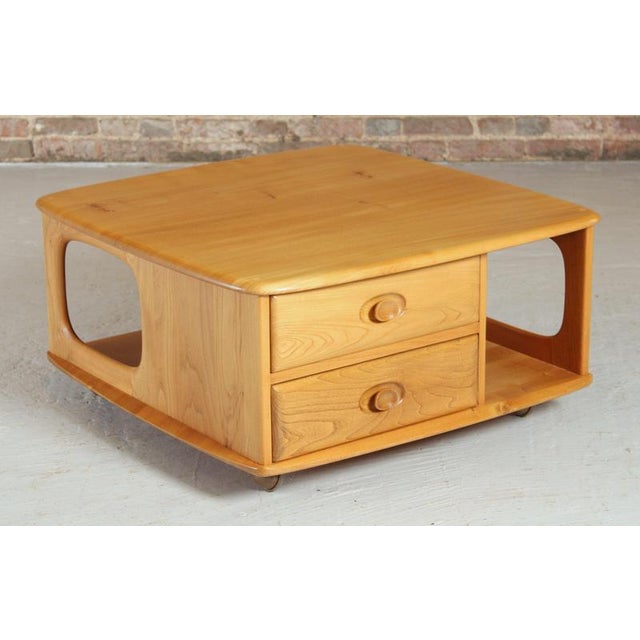Mid Century Ercol Pandora's Box beech and elm occasional table on casters, circa 1970s. Excellent restored condition. W...