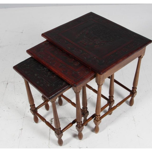 Ecuadorian nest tables by Angel Pazmino for Meubles de Estilo. Solid teak, table tops in brown saddle leather embossed...