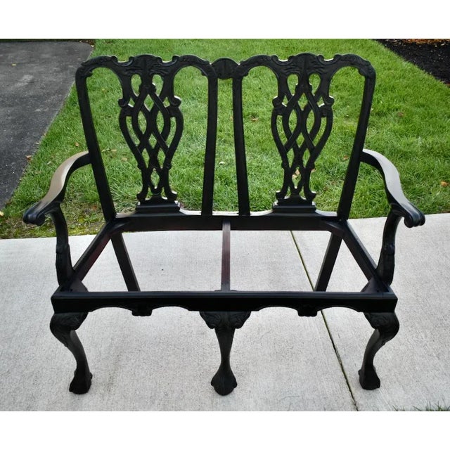 Vintage (1990's) Two Seater Bench has a Chippendale Style. The Frame is Wood. That has a Black Finish. Previously...