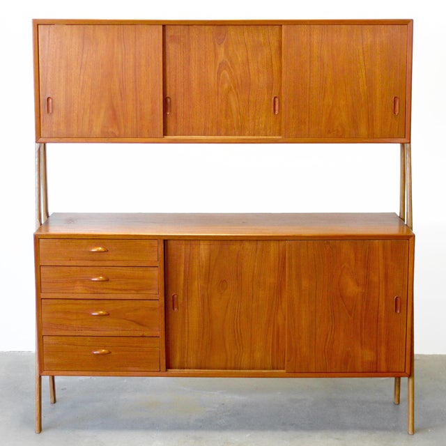 This highboard offers a great alternative to an ordinary storage piece like a hutch. It has sliding doors concealing...