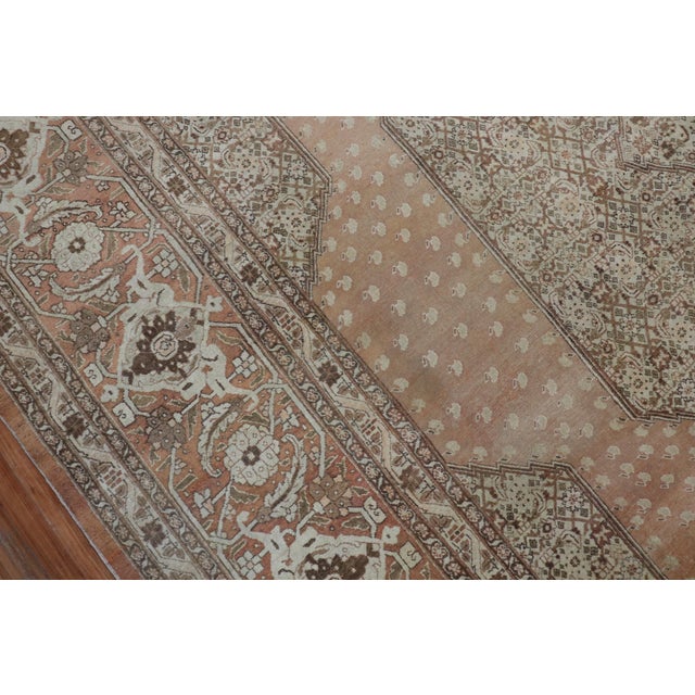 An authentic handmade early 20th century antique Persian Tabriz rug with Classic open scale medallion Herati design....