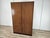An elegant vintage wardrobe from the 1960s, featuring a simple and refined design typical of mid-20th-century Italian...