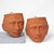 A striking pair of vintage terracotta wall planters sculpted in the form of mythological Greek or Roman male god faces....
