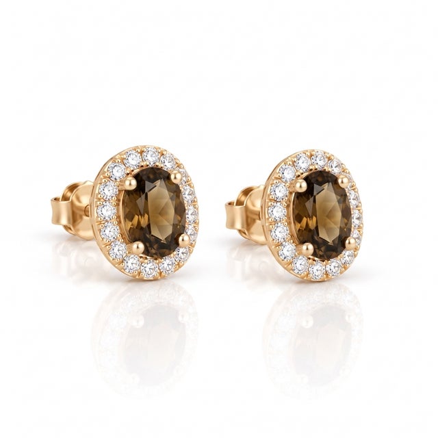 Exude subtle sophistication with these chic smoky topaz oval halo stud earrings. Featuring a rich earthy-brown gemstone...