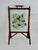 This free-standing hearth piece features a sturdy natural tortoiseshell- finish bamboo frame raised on classic trestle-...