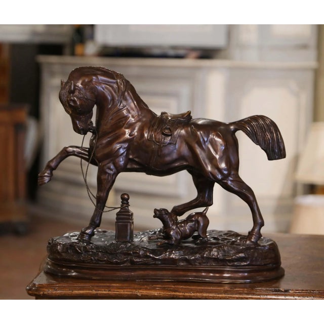 Full of movement and expressive detail, this antique-style bronze horse sculpture captures the spirited character of a...