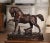 Full of movement and expressive detail, this antique-style bronze horse sculpture captures the spirited character of a...