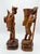 This is an exceptional, highly detailed pair of vintage mid-century hand-carved wooden folk art statues depicting the...