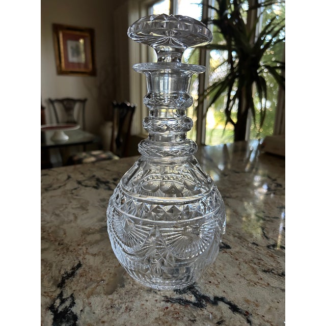 Anglo-Irish Heavy Cut Lead Crystal decanter with triple ring and mushroom stopper. The body displays geometric cutting...