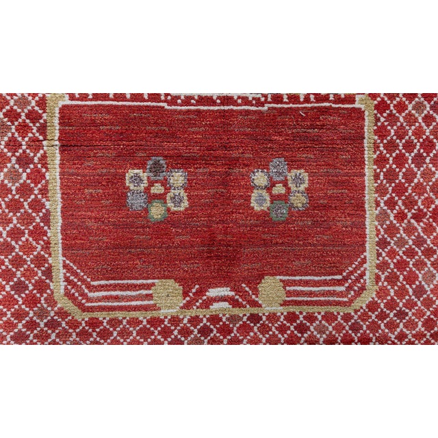 This contemporary Swedish pile rug features a richly textured red field enlivened by an intricate lattice pattern rendered...