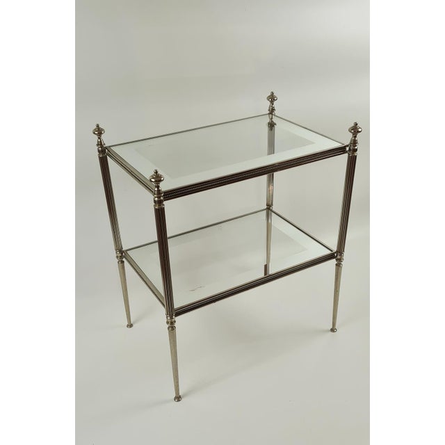 This French side table from the 1950s is made of silver-plated brass and eglomise glass. The structure is based on a...