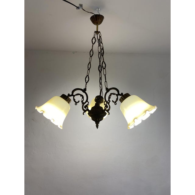 Decorative three-light chandelier sourced in Slovenia and dating approximately from the 1960s–1970s Yugoslav period. The...