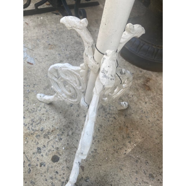 Three Cast Aluminum Marble Top Side Tables, 20th c., the circular white marble on a cylindrical support to three pierced...