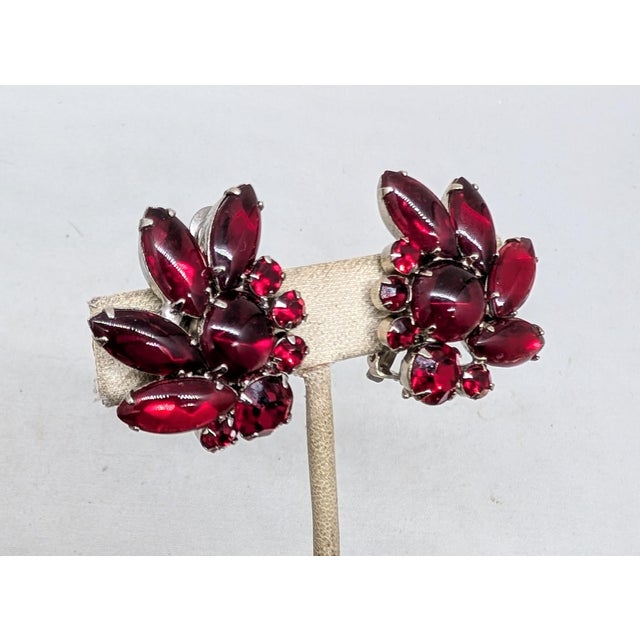 1960s rhodium plated prong set cabochon faux-garnet center with cabochon marquise faux-garnets and round faux-garnets clip...