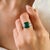 This Art Deco-style ring features a 1 octagon cut emerald totaling 4.37 carats, set in rich 14k white gold. The emerald...