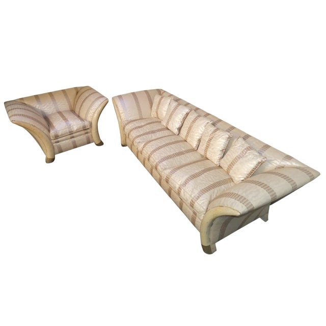 Sofa and armchair set with "elephant tusk" (or saber) legs. A design classic that recalls the colonial style and taste of...