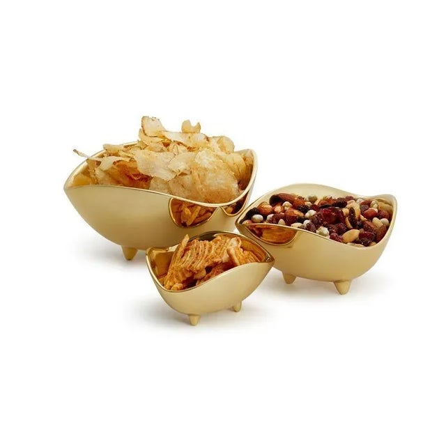 Expertly cast in brass, this beautifully weighted serving bowl adds sophistication and substance to a table. Styled with a...