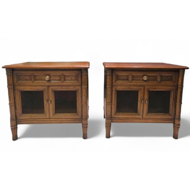 This Pair of Vintage Henredon Fine Furniture Walnut Nightstands with Metal Mesh Cabinet Doors has a clean classical...