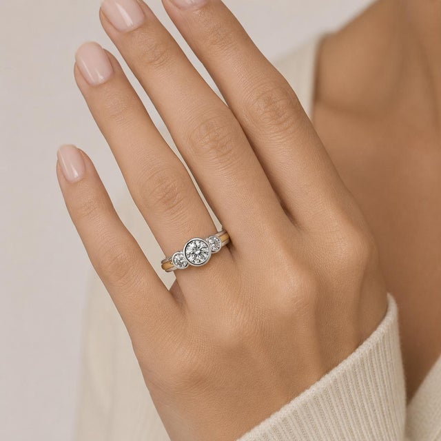 Platinum & 18k Three stone ring with three round brilliant diamonds weighing approximately 1.10 carats. size 6.75