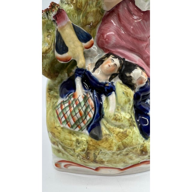A Antique English Staffordshire Figure With a Vase Circa 1860's Made in the Staffordshire district of Stoke on Trent,...