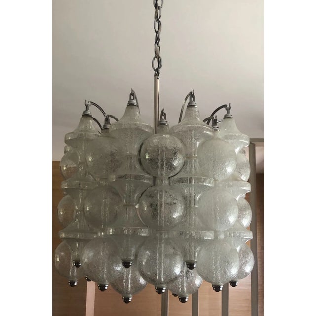 Gorgeous 1960s Mid-century hand-made bubble glass Tulipan Murano chandelier by Kalmar. Sure to make a statement in any...