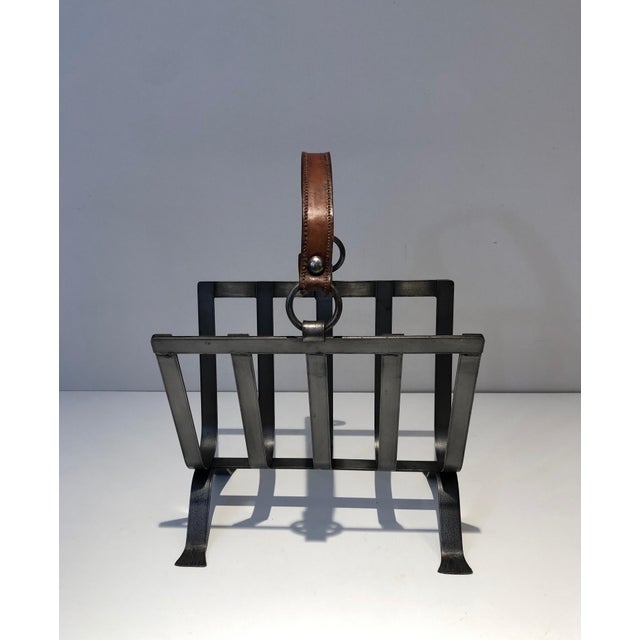 This unusual magazine rack is made of steel and leather. This is very beautiful, high quality work. This is a work in the...