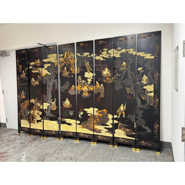 Design Plus Gallery presents a Chinese Lacquer Eight Immortals Mountain Cloud Eight-Panel Screen. The design shows robed...