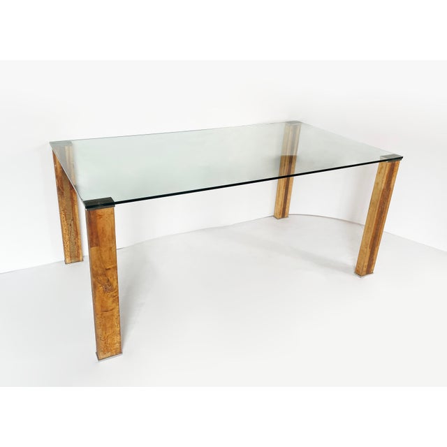 Vintage Italian design table from the 1970s–1980s with a glass top and cork-covered legs with dark wood inserts. Clean...