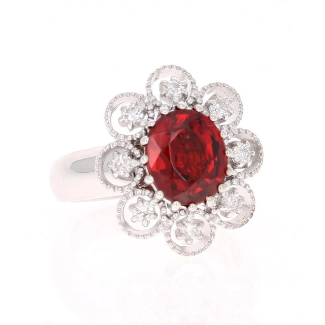 This simple but unique ring has a gorgeous 3.68 Carat Oval Cut Spessartine Garnet. Spessartines are natural gemstones and...