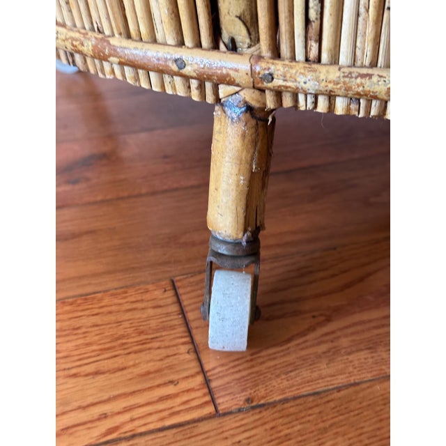 A fine Italian bar cart or trolley in rattan and bamboo from the 1960s, featuring a barrel-shaped design with curved...