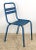 Vintage European Tolix style blue steel chair featuring a rectangular slatted backrest with a cutout at the top and four...